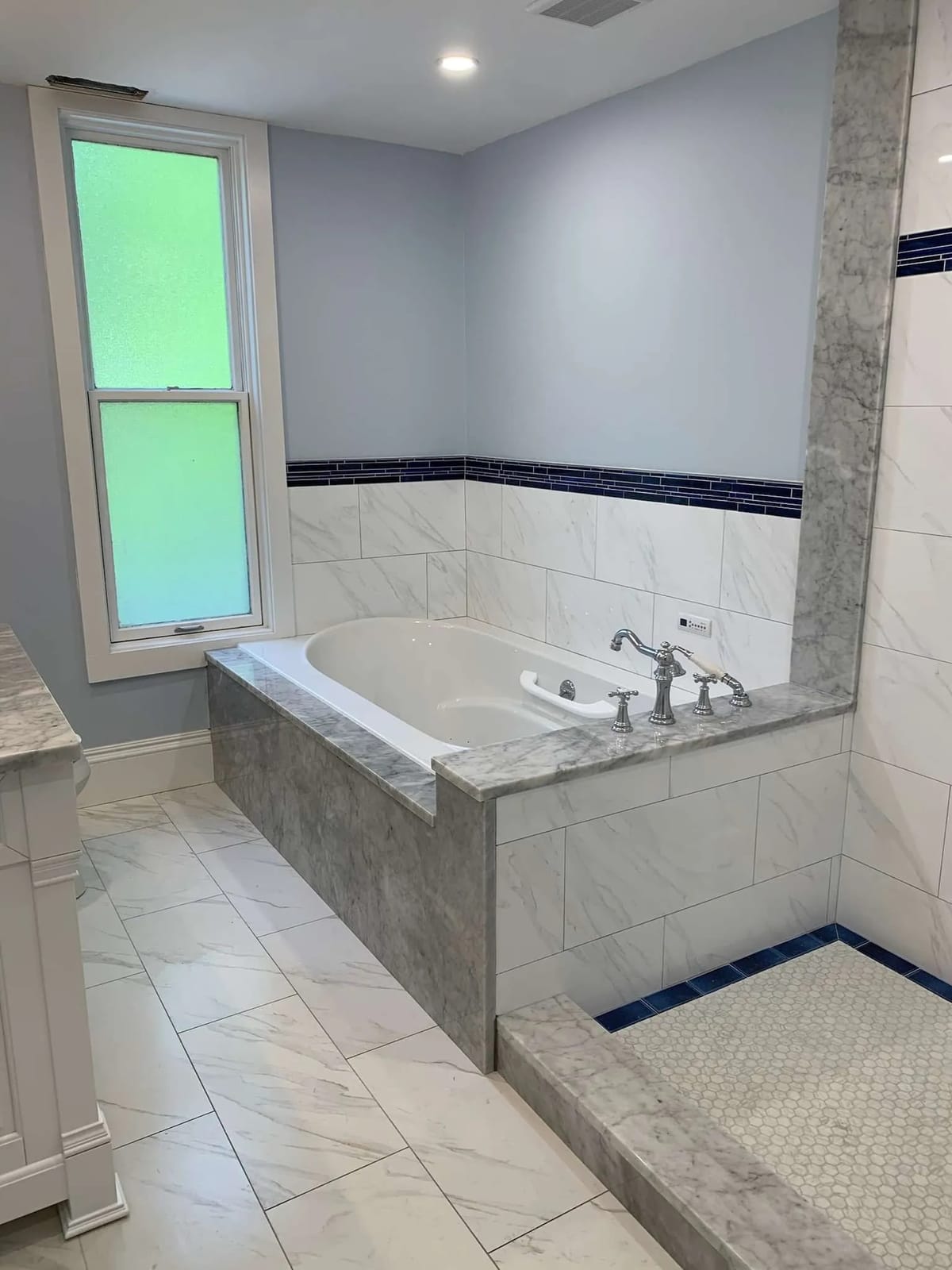 Bathroom remodel: tub deck with navy accent band