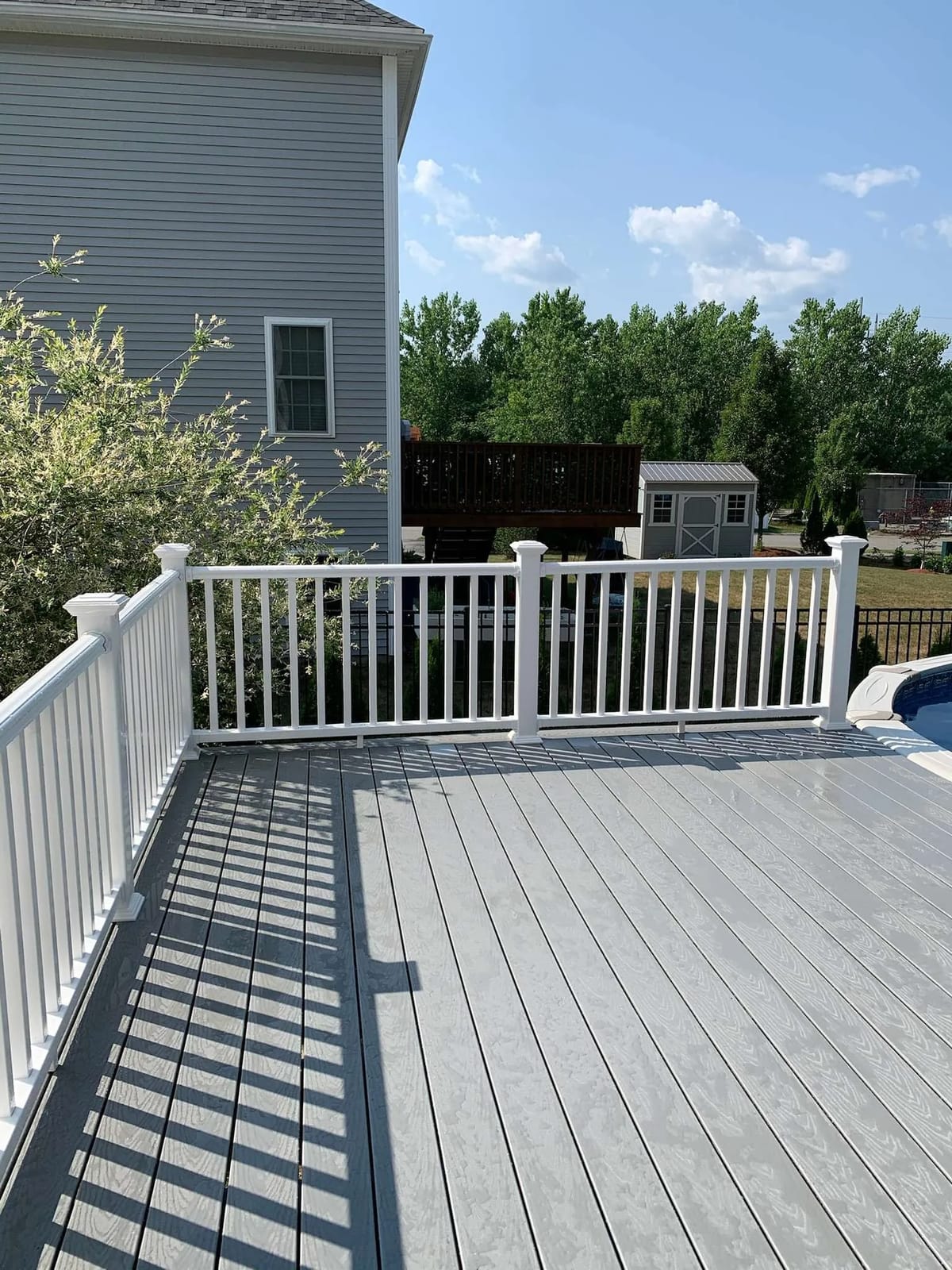 Deck build: gray deck with white railings