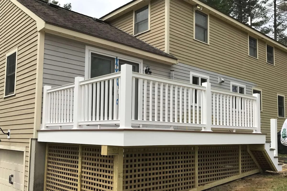 Deck build: railings on. Lattice skirting closes the base