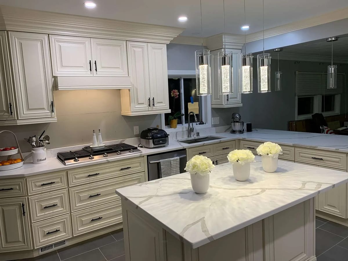 Kitchen remodel: cream cabinets and marble-look island