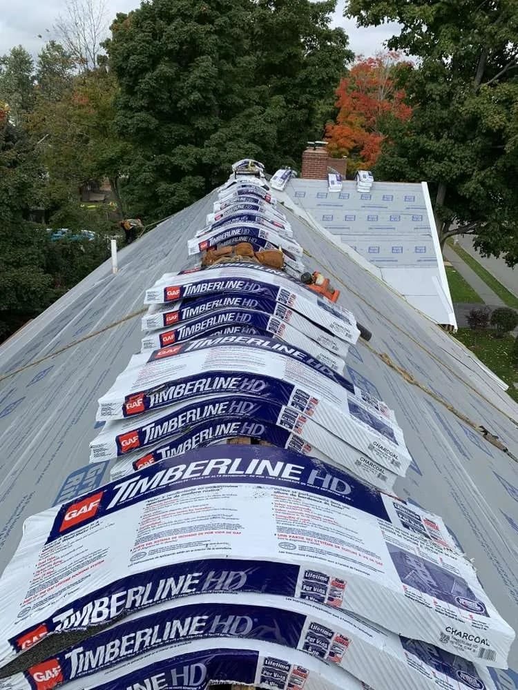 Roof replacement: shingles staged on the ridge